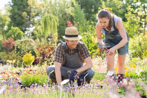 Front view of a gardener inspecting a residential garden